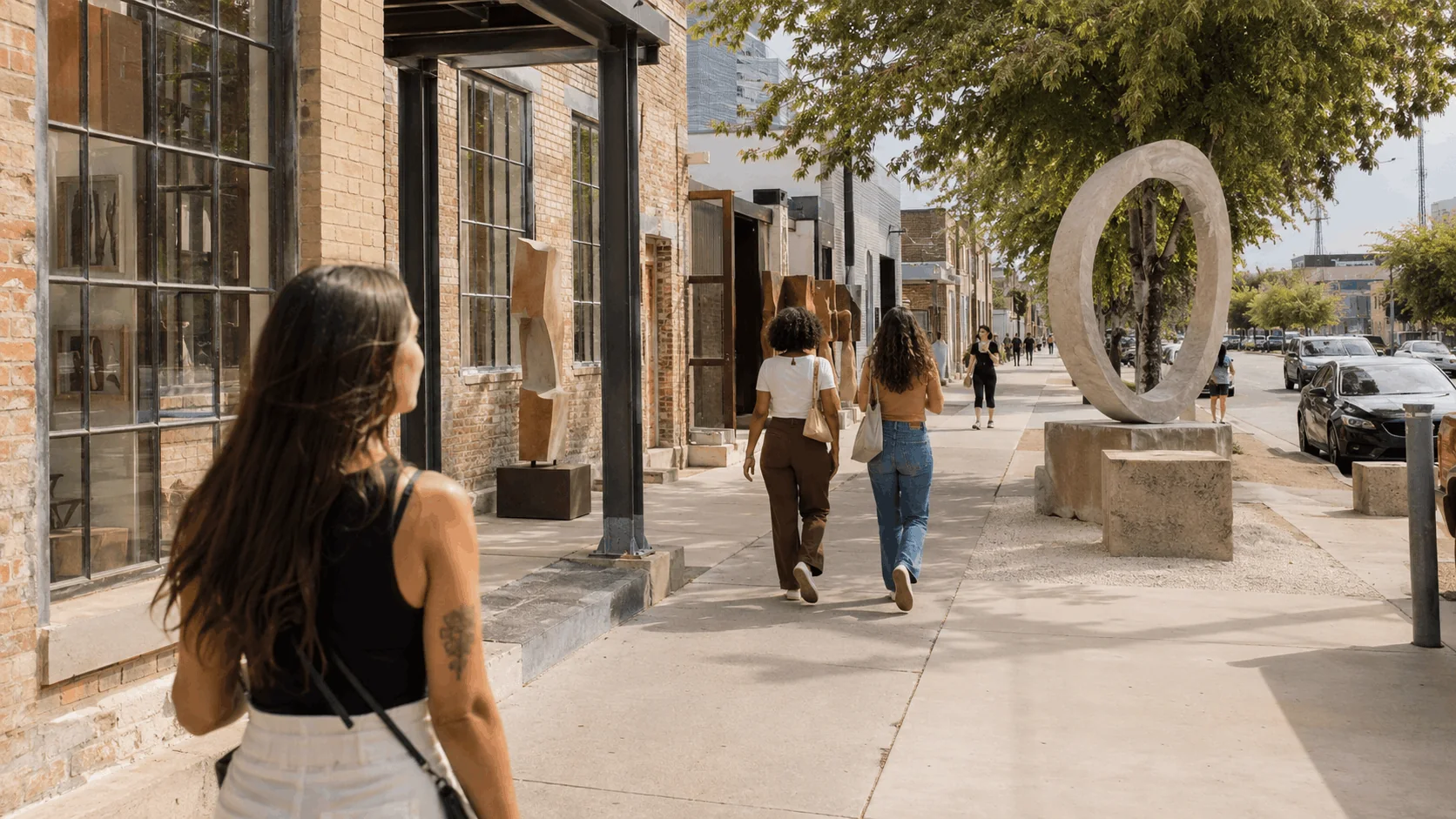 Pedestrians exploring the arts district near galleries and public art installations in Southtown.