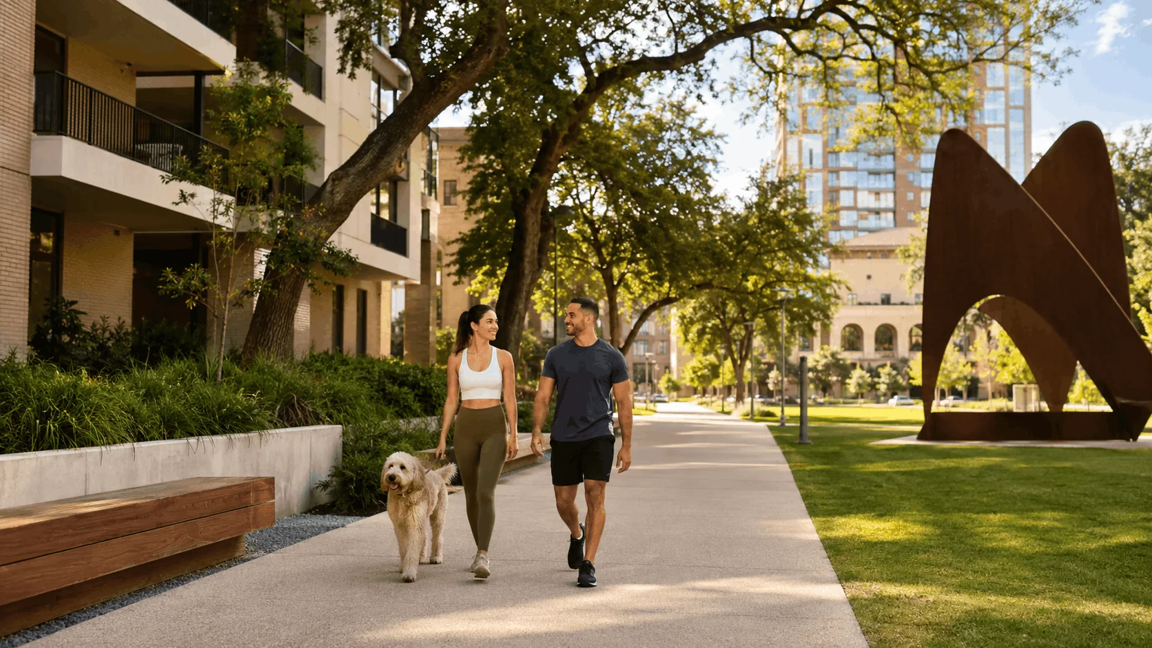 Couple walking their dog along the landscaped paths near Hemisfair Park in San Antonio.